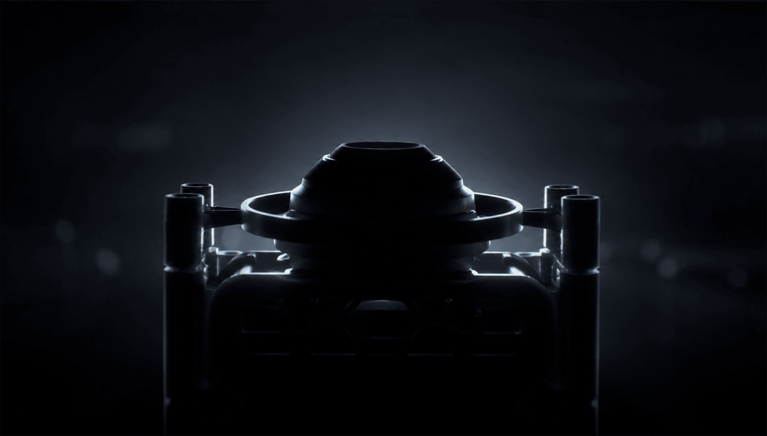 The XENSUR surgical training instrument, rim-lit in the dark